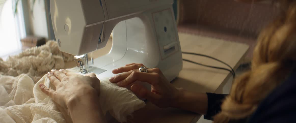 Seamstress sewing a dress in a sewing machine