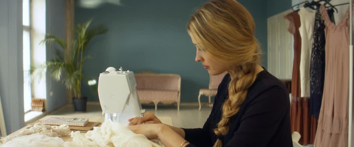A woman is using a sewing machine