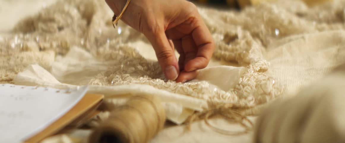 A person is examining fabric