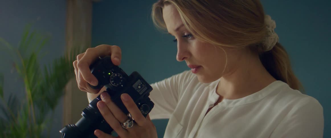 A woman taking photos with a camera