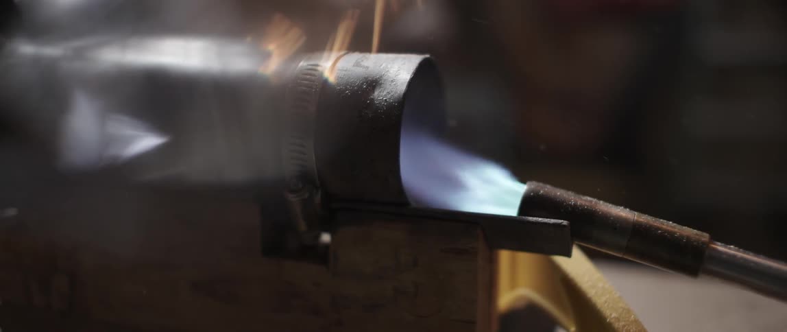 A torch shoots fire into a tube