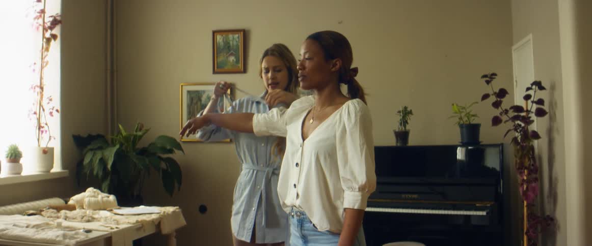 Clothes designer measuring a client for a custom made dress