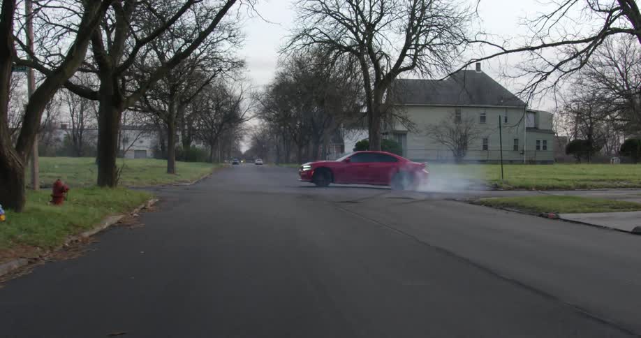 A car doing burnouts on a street