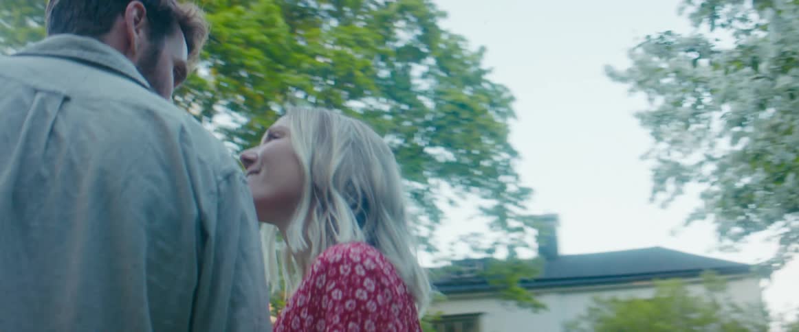A boyfriend and girlfriend walking outside