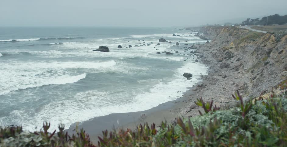 A view of cliffs at the edge of the beach and ocean