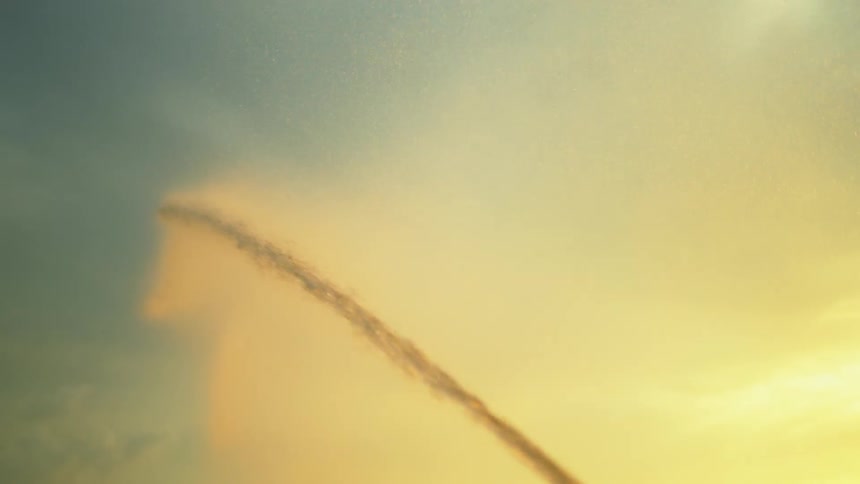 Yellow spray against a blue sky