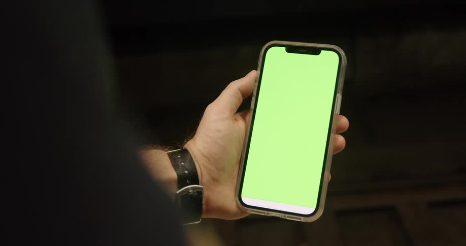 Person holding a smartphone with a green replaceable screen