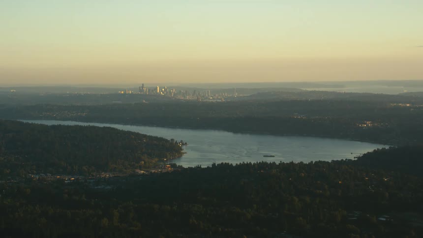 Aerial shot of a river with a city in the distance