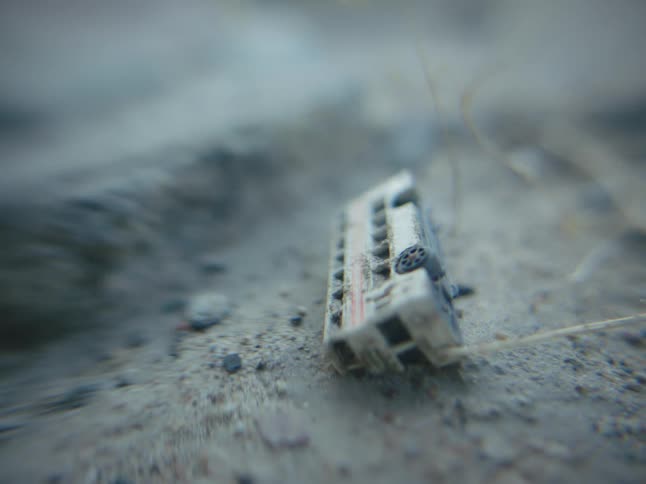 A toy is placed on the sand outdoors