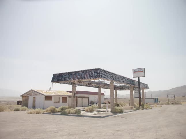 A woman dances under a shelter at a rural visitor center