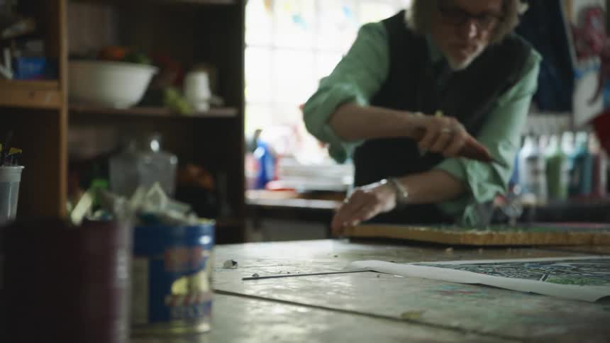 A man working on an art project in his shop