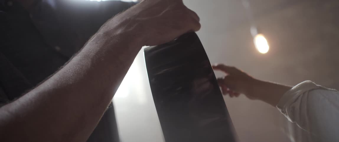 Two people trace their hands on a guitar