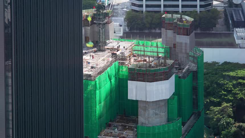 Workers move around construction site as building goes up