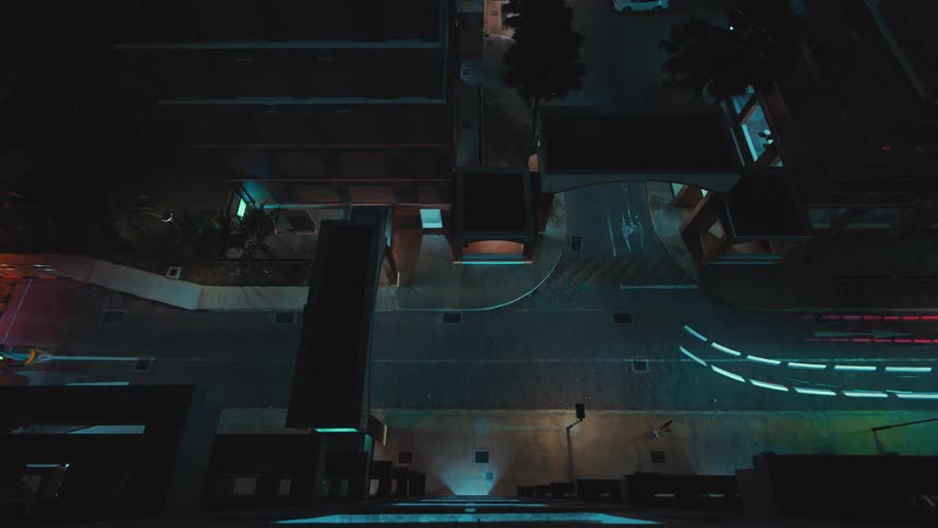 A time lapse shows cars driving along a city street and turning at an intersection
