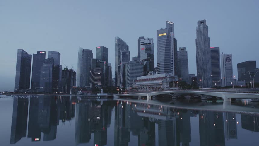A time lapse cycles from day to night and shows a large metropolitan city next to the water