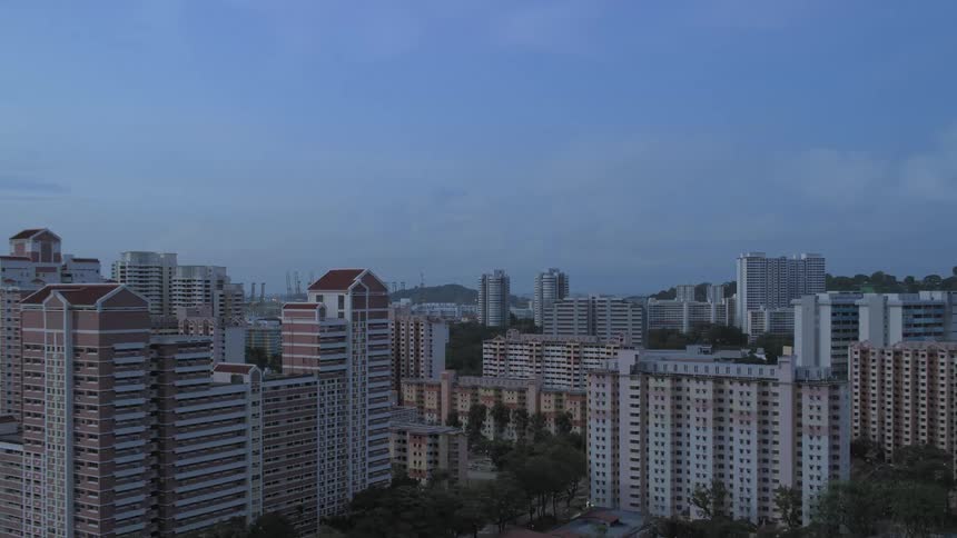 Time lapse of buildings in a city skyline off the shore
