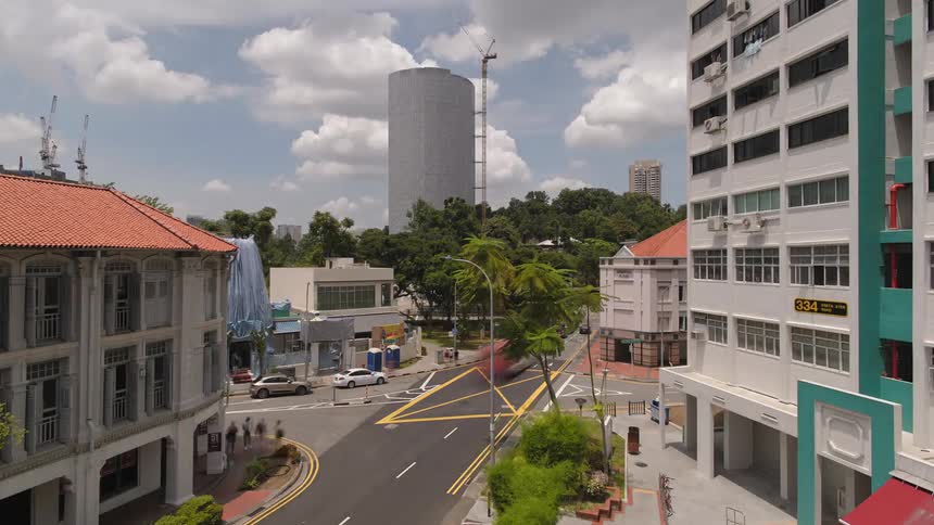 A time lapse shows a busy city intersection and a building constructed