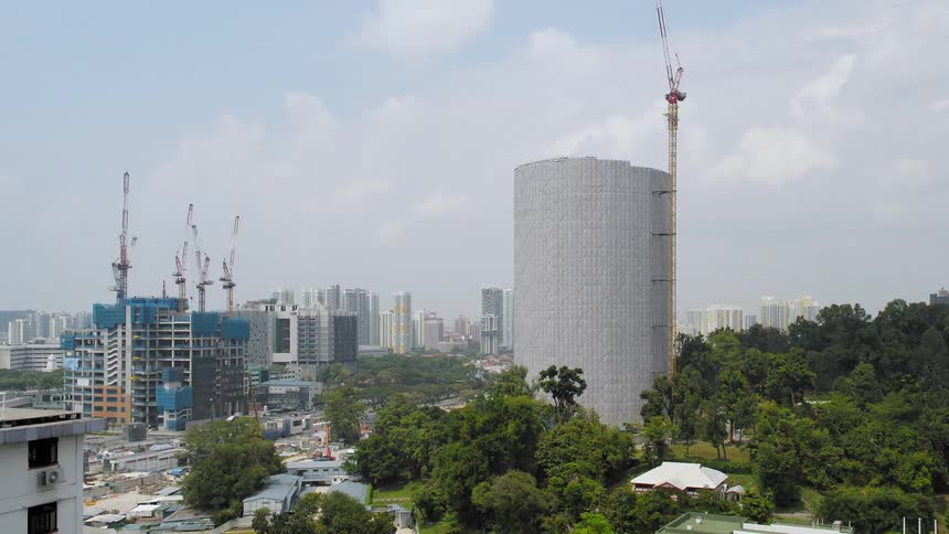Constructing high rise buildings against the cloudy sky