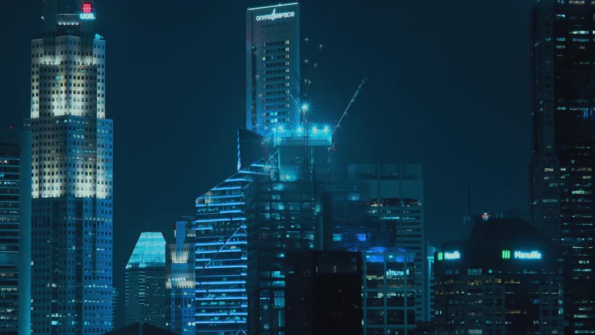 View of high rise building construction at night in the city