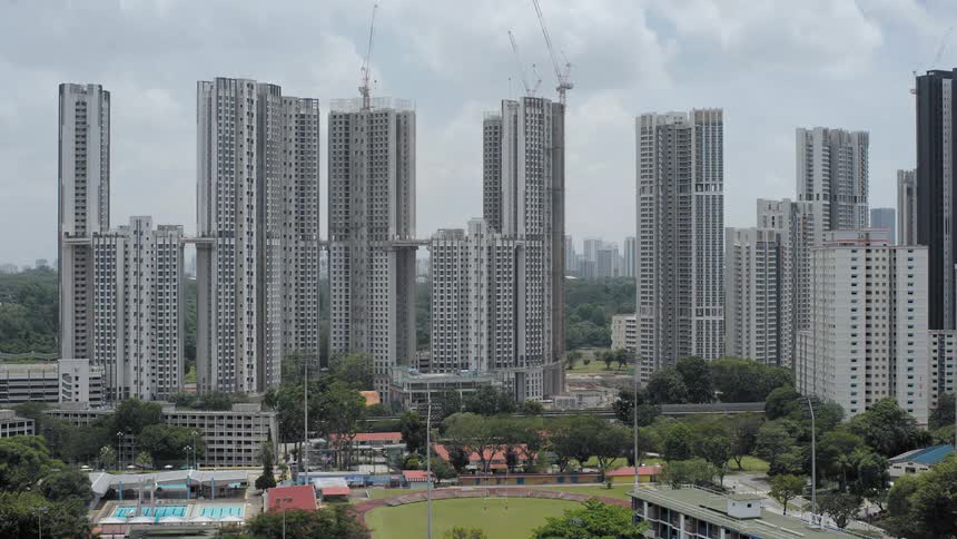 Multiple skyscrapers go up at the same time near a downtown park