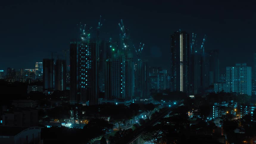 Traffic passes by tall skyscrapers downtown at night