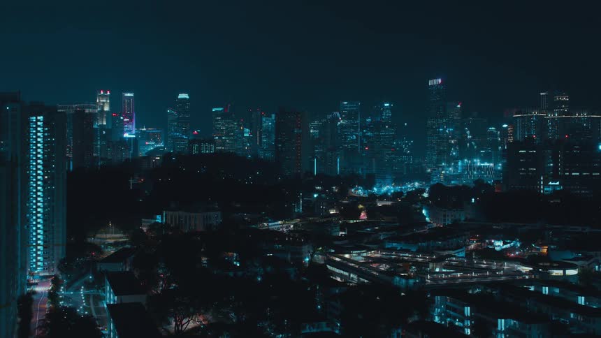 An aerial time lapse of a large city at night reveals many lights and construction activity