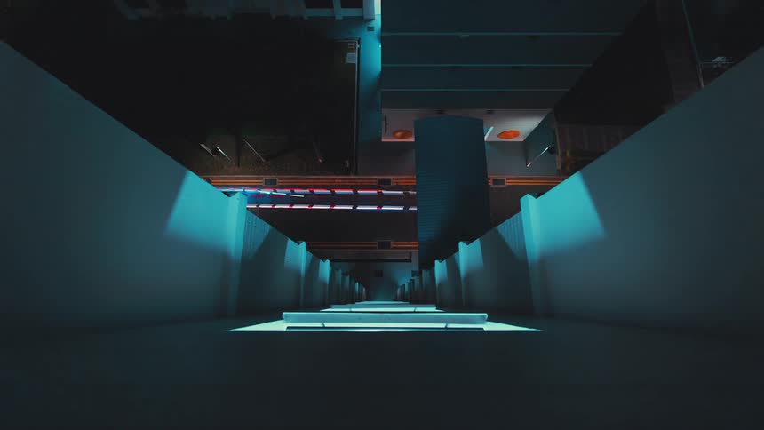 Directly below a tall building the traffic passing by is shown in a time lapse
