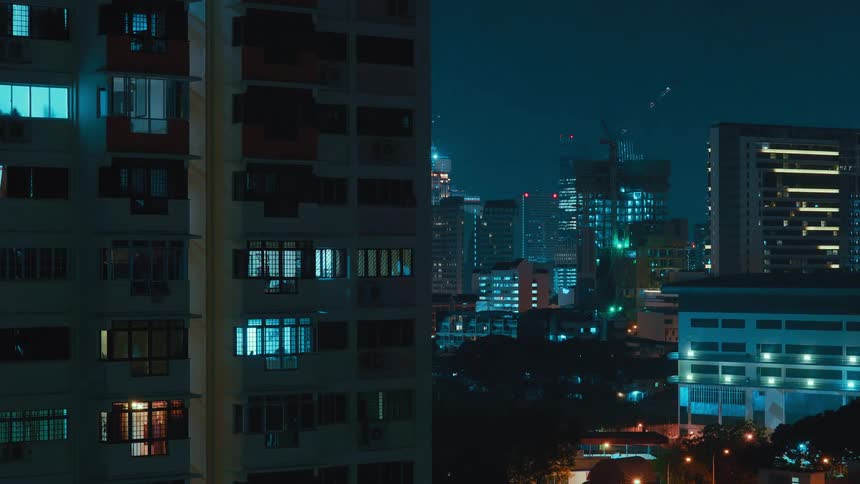 A city skyline with buildings and construction cranes with the sky in the background
