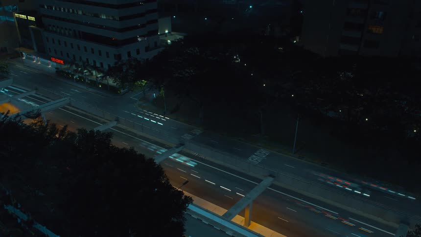 Cars drive on the road at night