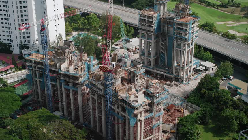 A time lapse shows a buildings being constructed by multiple large cranes