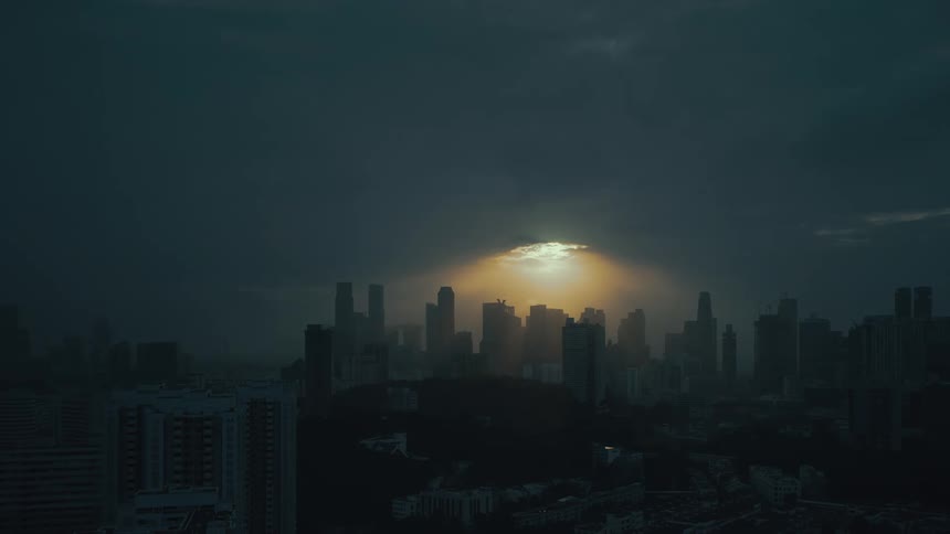 The sun is setting on the city and grows dark
