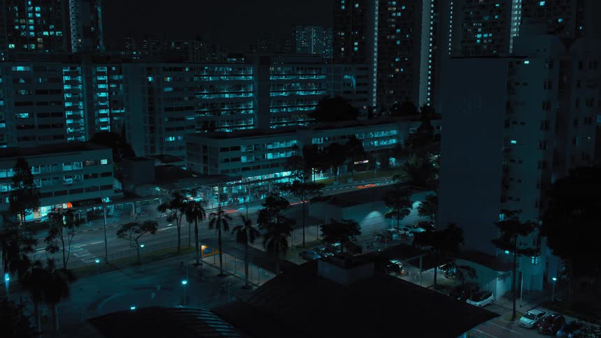 Traffic travels along a road through a metropolis at night