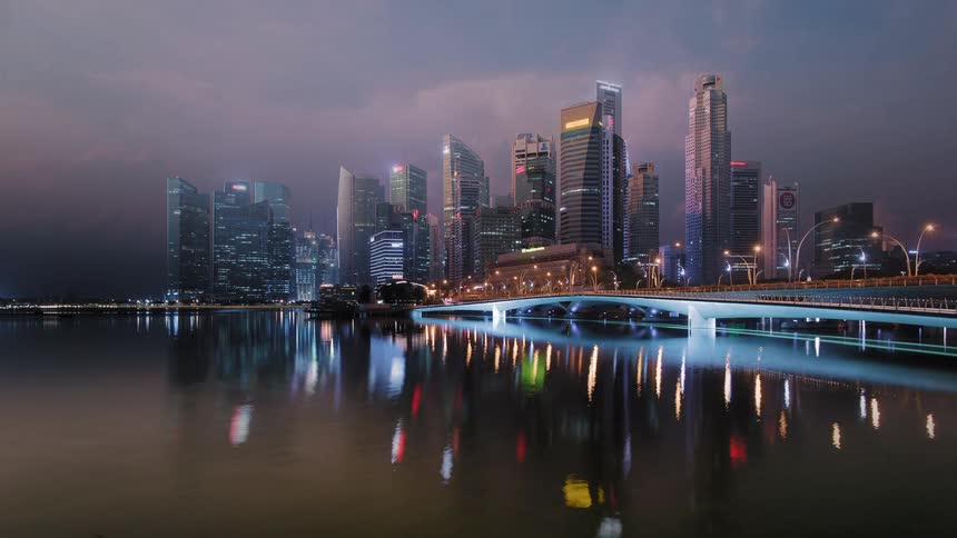 Singapore skyline and bridge glow and shimmer with light reflecting off the water