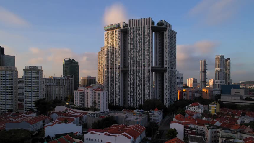 A city skyline that is filled with several skyscrapers is shown in  a night to day timelapse