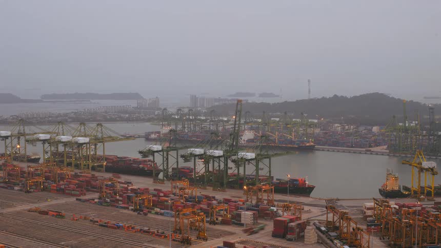 Time lapse of cargo ships unloading shipping containers at port