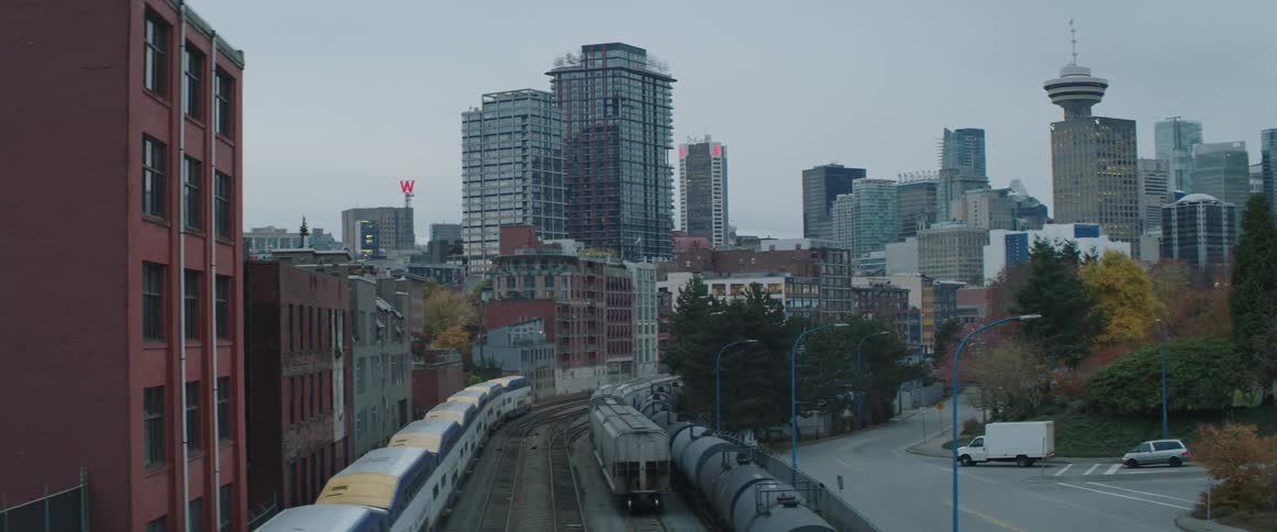 A train passes along the tracks that are located near downtown Vancouver