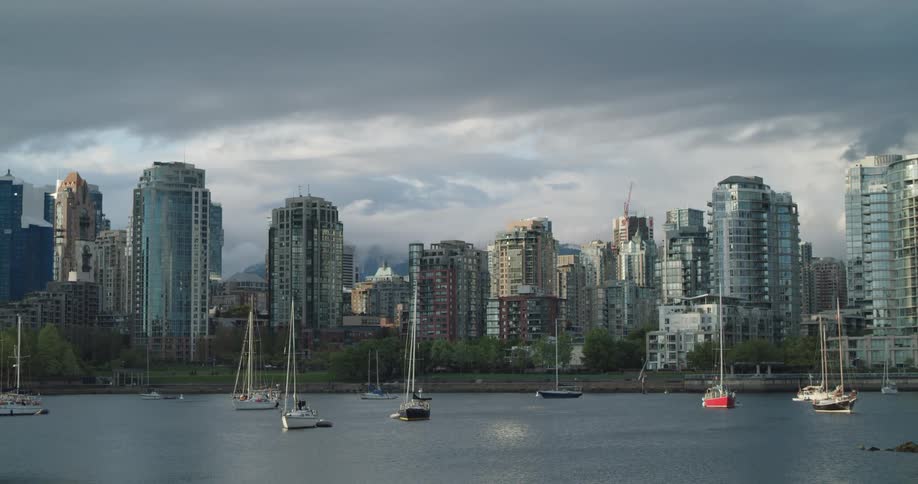 Sailboats meander in the water near downtown Vancouver