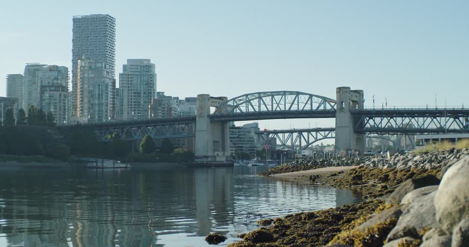 View of Vancouver's Burrard Bridge from the nearby shore at dawn