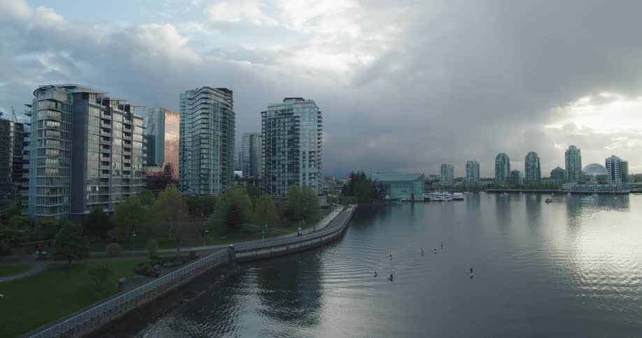 Kayakers paddling on the water during a stormy day in the city