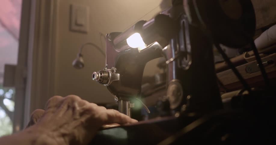 A man is working using a sewing machine