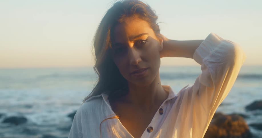 A portrait of a woman standing at the beach
