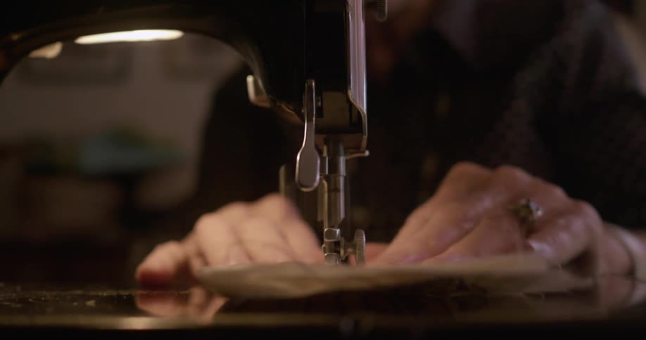 Old person sewing with a sewing machine