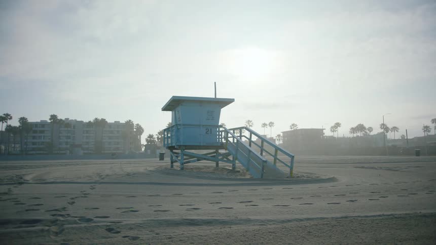 An empty beach is displayed at dusk