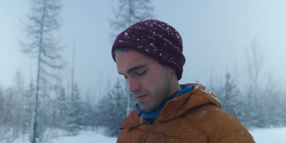 A man taking a photo with a camera in winter
