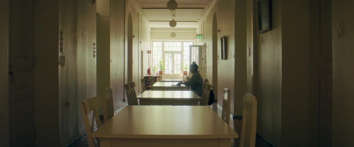 A woman sitting at a table writing