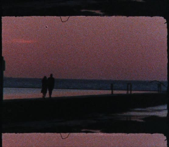 Man and woman walk next to the lake