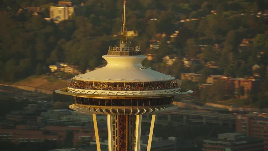 Hundreds of people crowd onto observation decks at the space needle in seattle