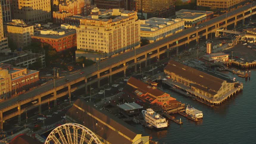 A city with a marina a ferris wheel buildings roads and vehicles