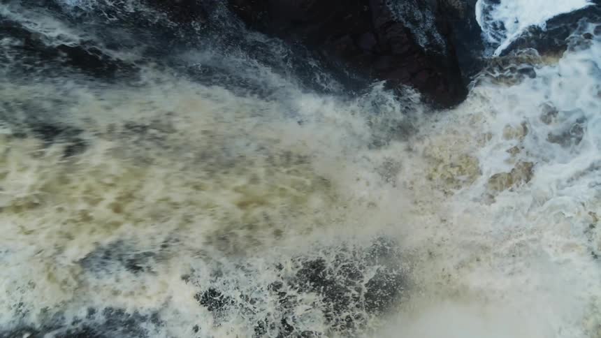 River water flows down a rocky cliff