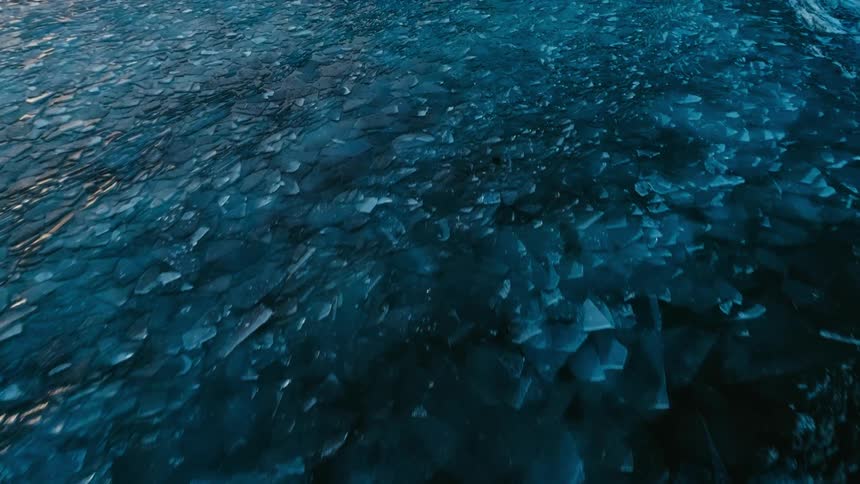 Ice chunks float in the ocean water